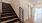 stairway with wood flooring and black iron railing