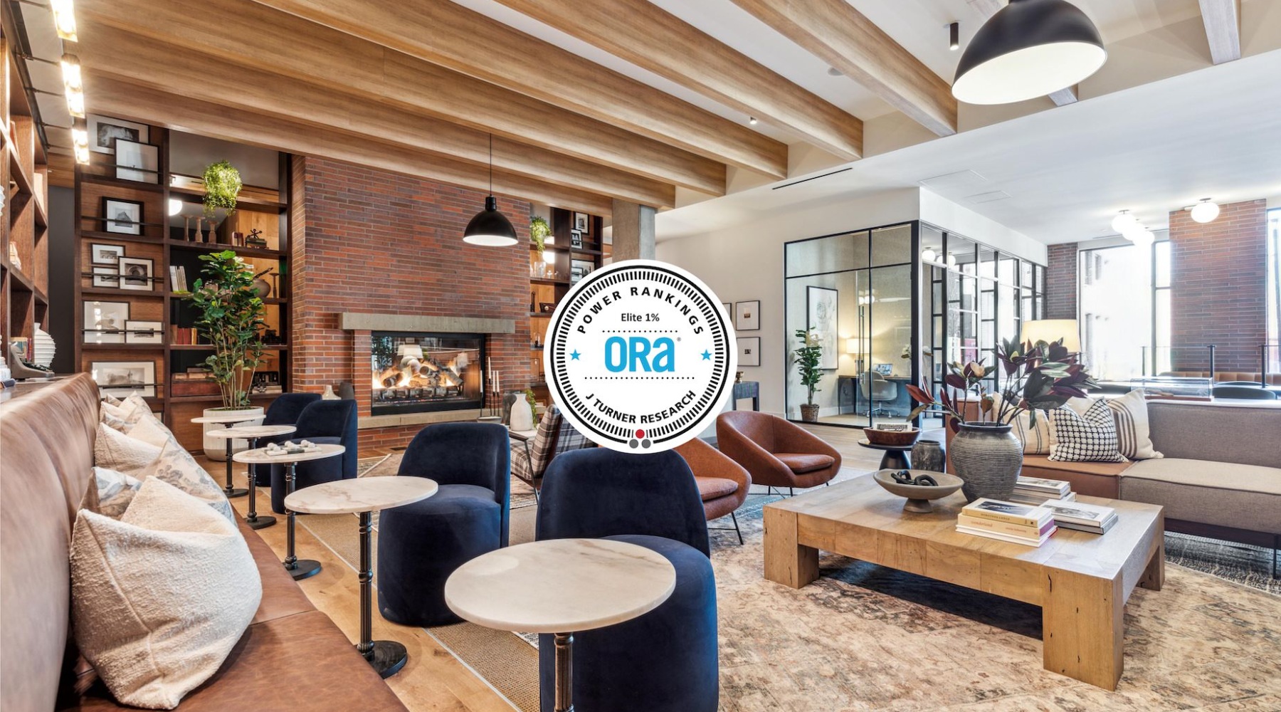 ORA Elite 1%  lounge area with seating tables and fireplace J Coopers Row luxury sw dc apartments ballpark