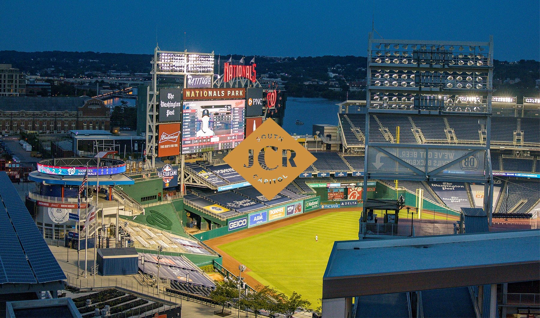 Apartments near Washington Nationals Stadium evening view into baseball field with scoreboard and lights